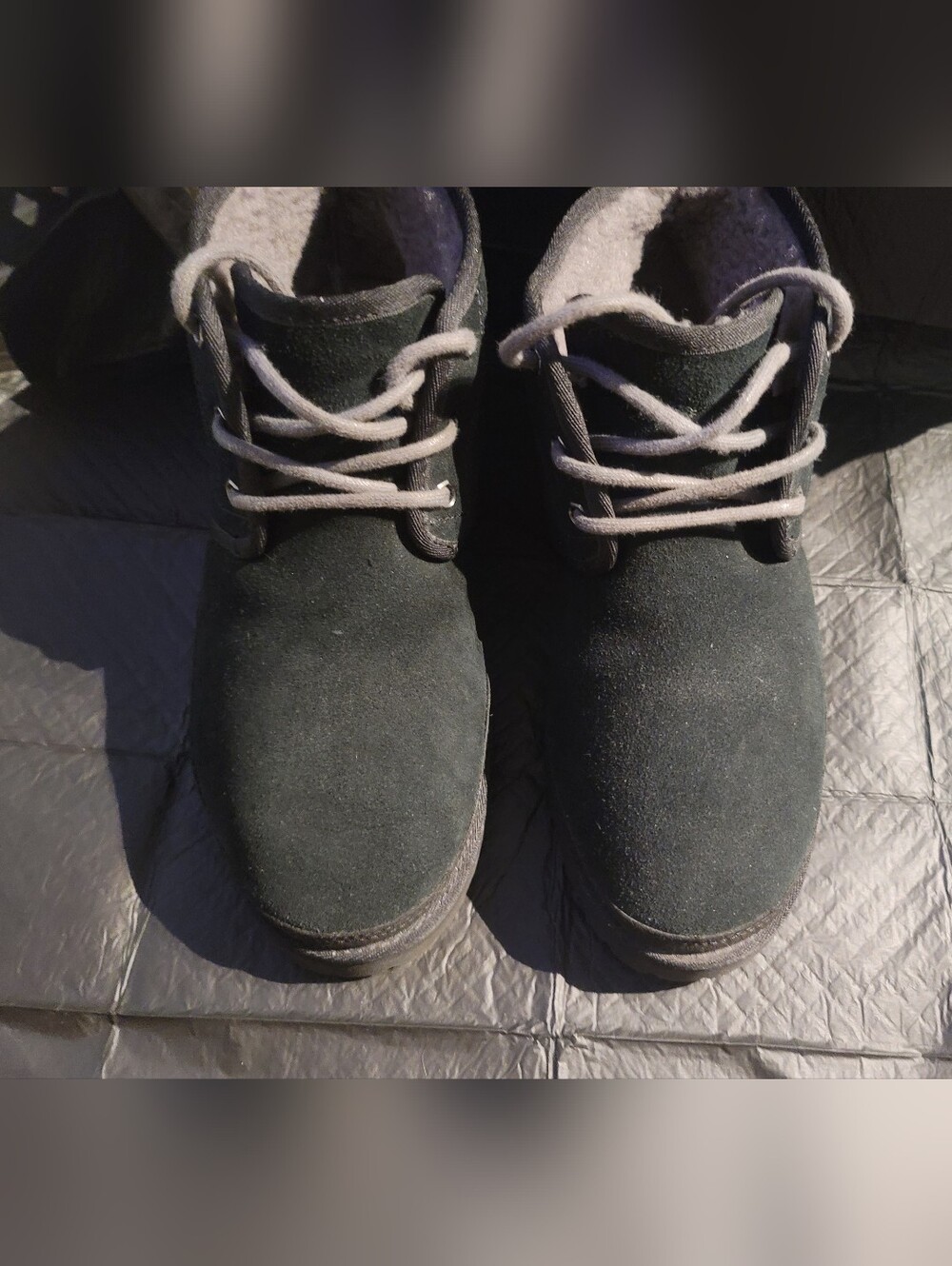 Black UGG Neumel chukka boots featuring suede uppers and sheepskin lining.